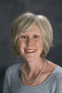 Professional headshot of Robyn Ridgley, Assistant Director of the Center for Teaching and Mentoring, in front of a gray background