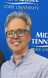 Headshot of Dr. Scott McDaniel in front of Middle Tennessee State University background