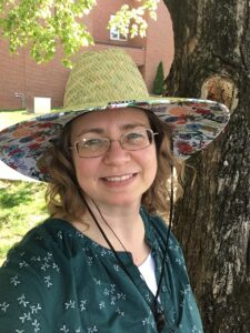 Photograph of Dr. Becky Seipalt-Thiemann outdoors, posing in front of a tree.