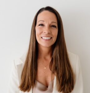 Headshot of Lucy Matthews, a professor in the department of marketing, in front of a light-colored background.